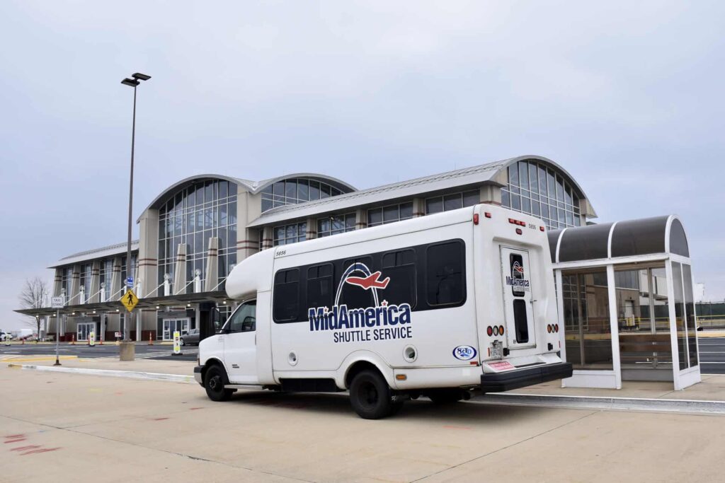 MidAmerica Shuttle Service van parked in front of terminal building