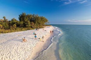 White sand beach with crystal clear water on clear day