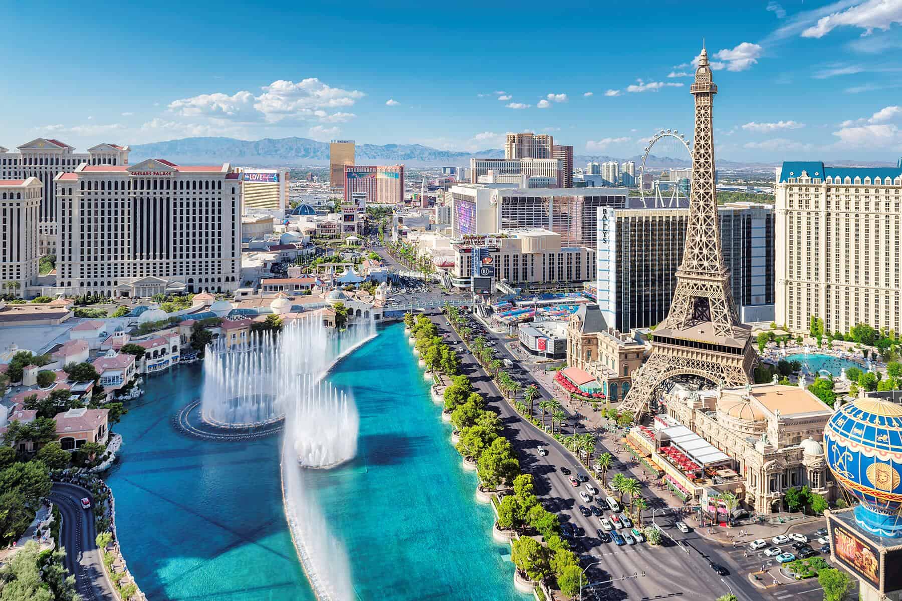 Las Vegas Strip with Bellagio Fountains and Paris Hotel on bright summer day