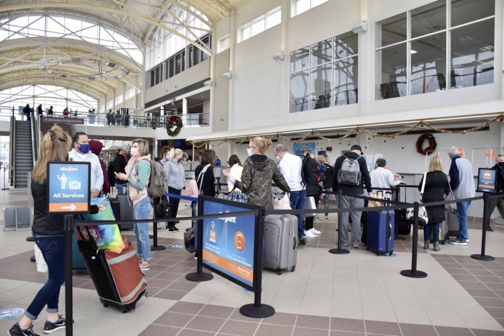 Passengers standing in line at ticket counters in MidAmerica Airport terminal